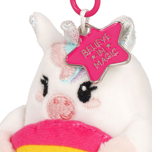 Plush unicorn keychain with a pink 'Believe in Magic' star charm on a white background