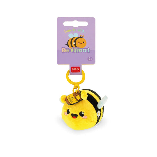 Plush bee keychain with a purple card on a white background