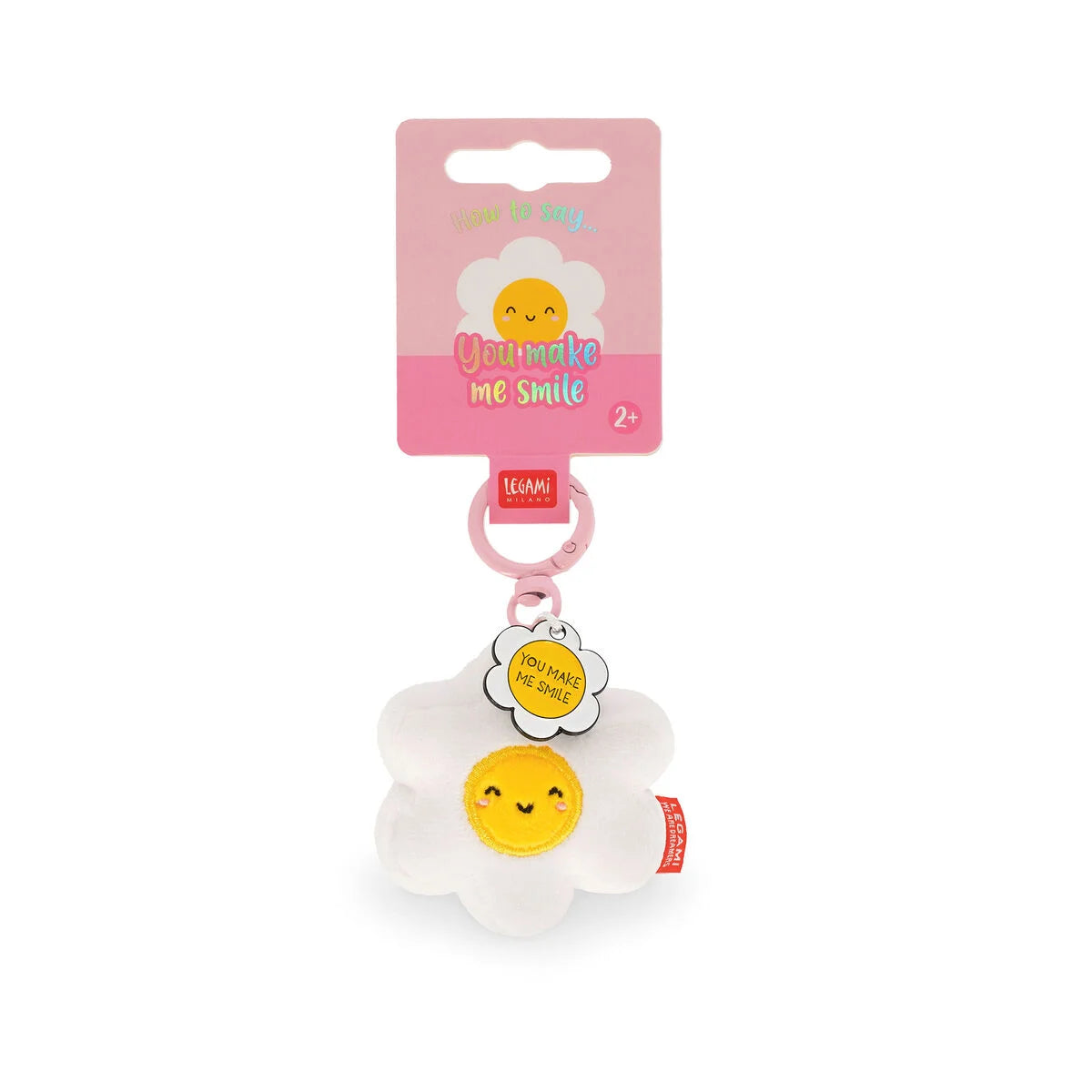 Plush key ring of a smiling daisy on a pink card tag