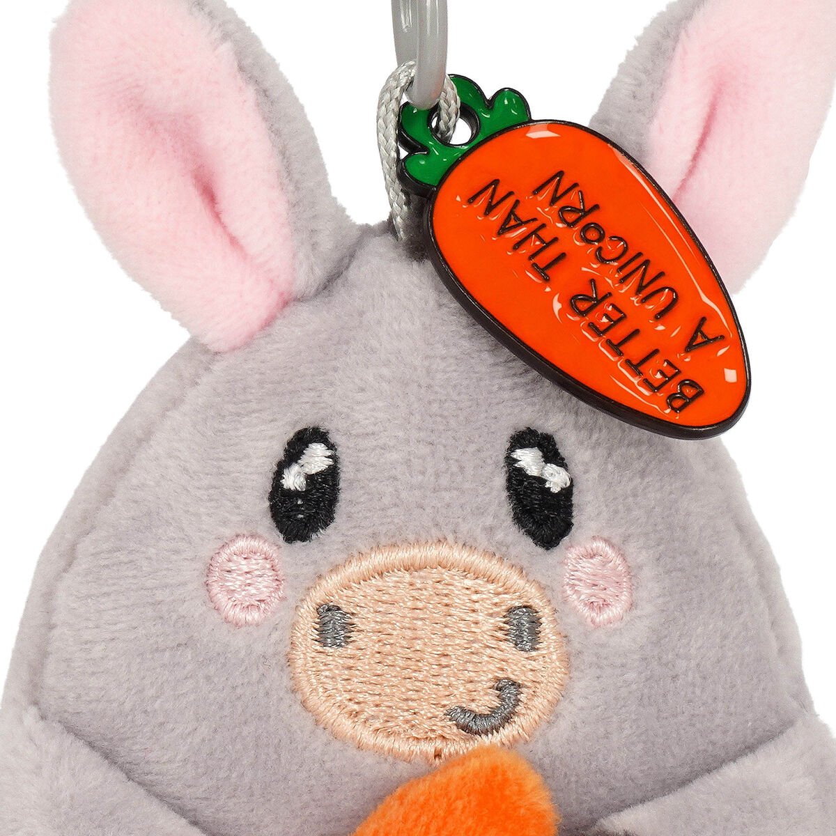 Plush donkey keychain with a carrot-shaped tag on a white background