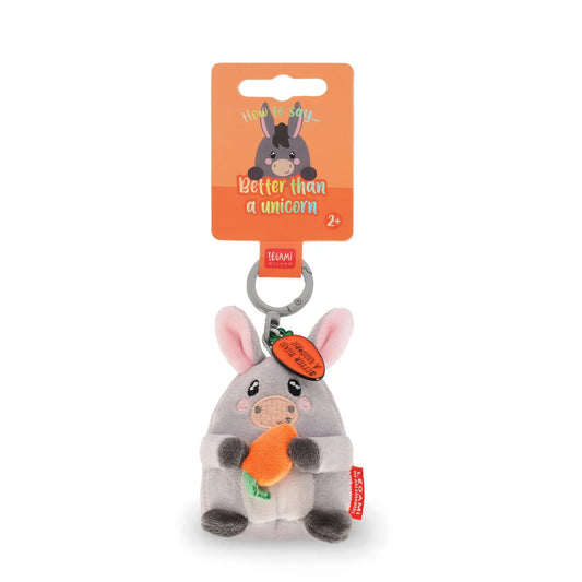 Plush donkey toy with carrot and tag on a white background
