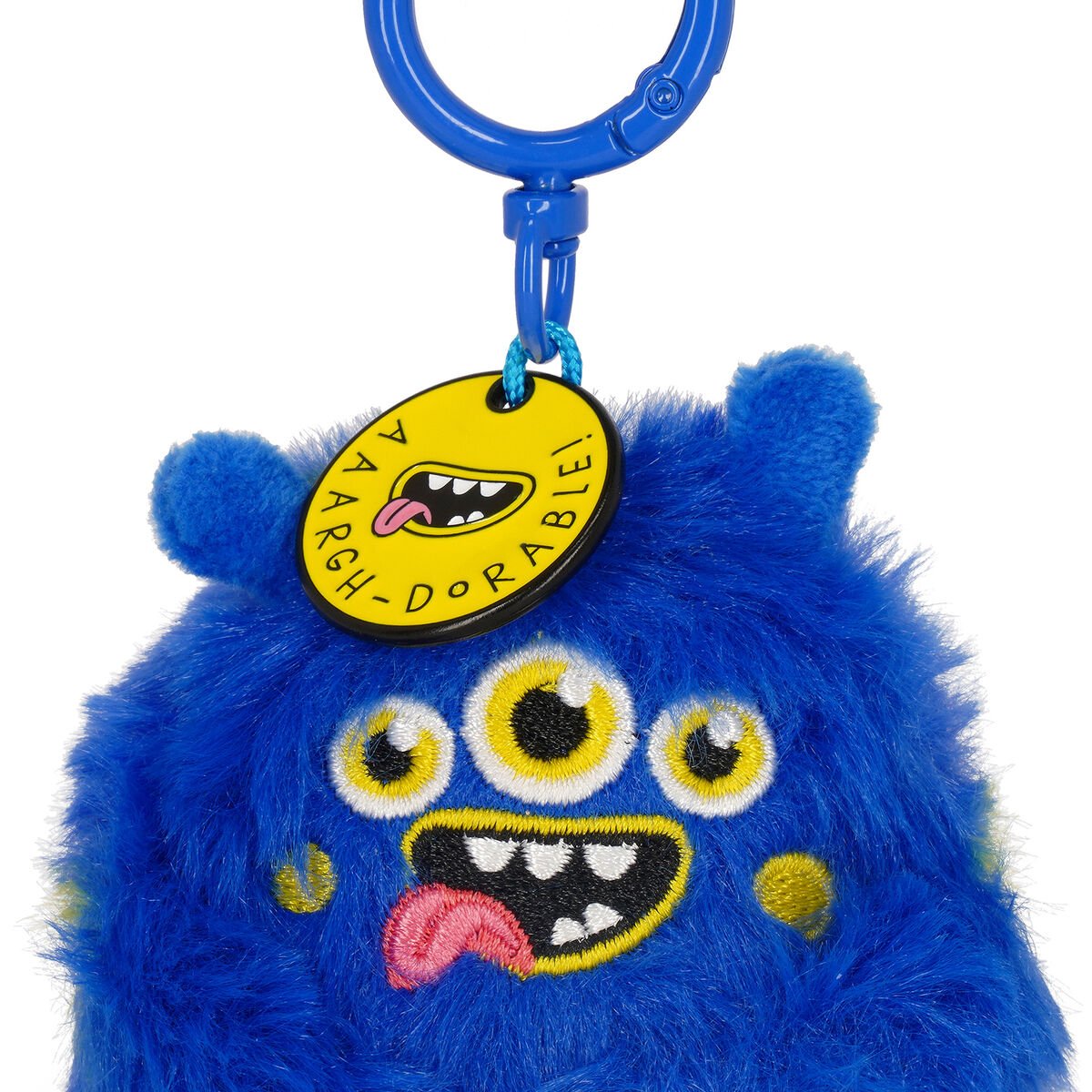 Blue fluffy monster keychain with a yellow tag on a white background